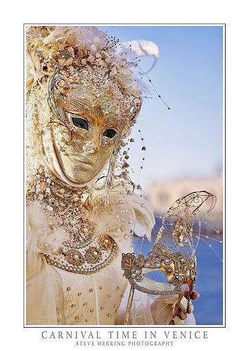 A Woman Wearing A Gold Mask And Dress With Feathers On Her Head