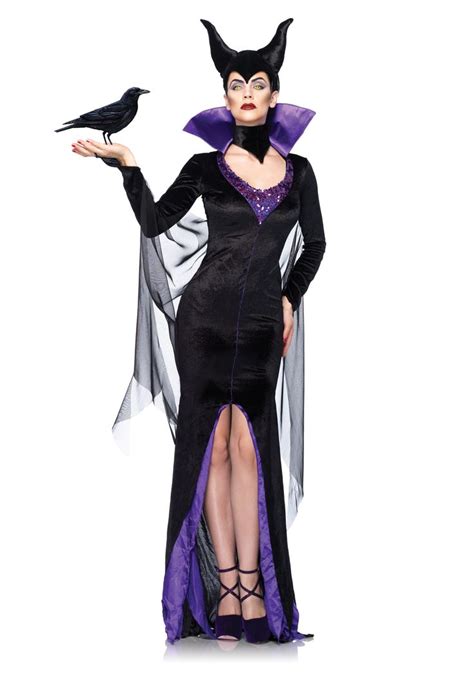 a woman dressed in a black and purple costume with a crow on her ...