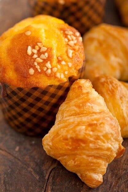 Premium Photo Close Up Of Croissant And Muffin On Table