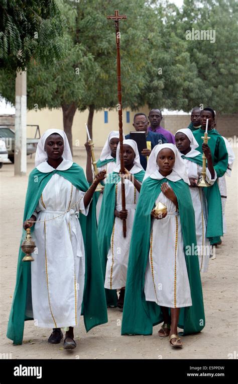 Altar Girls With Candles Proceeding To A Sunday Service In The Catholic