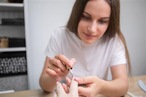 Premium Photo Nail Care And Manicure Woman Applying Nail Polish On