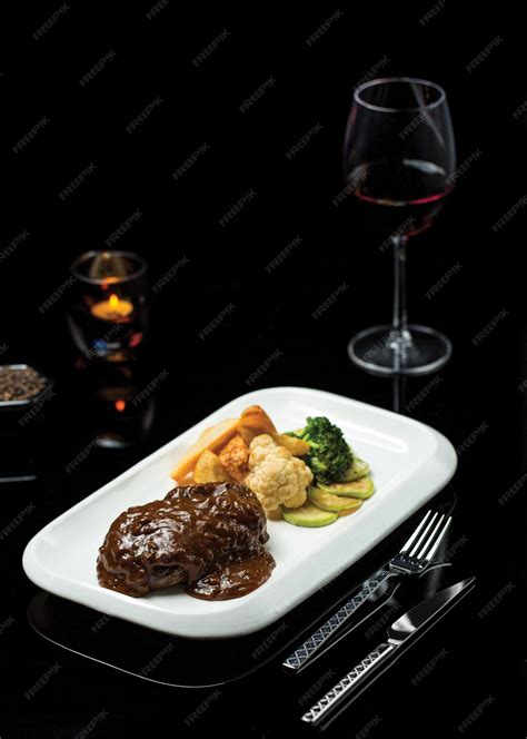 Free Photo | Ribeye steak in teriyaki sauce with glass of burgundy