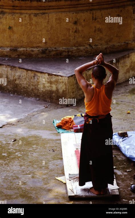 Buddhist Monk Praying At The Mahabodhi Temple At Bodhgaya In India