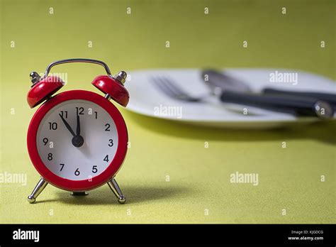 Time To Eat Concept Clock On Plate Stock Photo Alamy