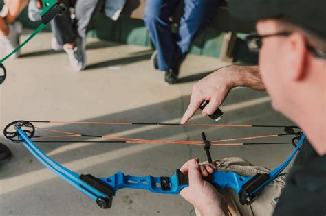 man holding  compound bow  stock photo