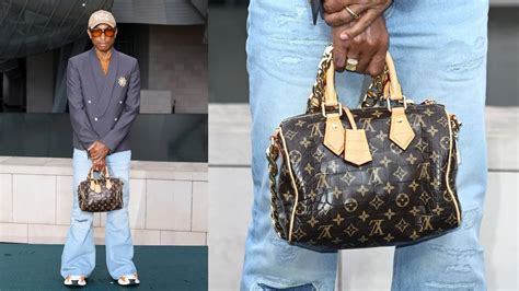 Pharrell Williams Shows Off New Louis Vuitton Man Purse at Olympics