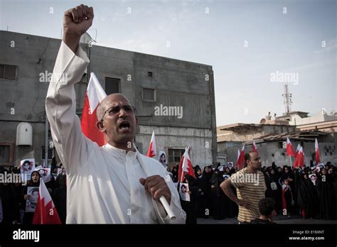 A Man Carrying The Bahraini Flag And Cheer Slogans Against The Bahraini