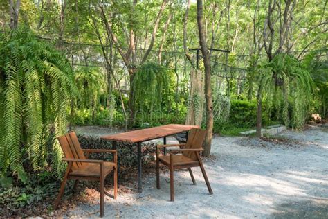 Outdoor Wooden Table and Chairs with with Beautiful Garden Stock Image - Image of outdoor ...