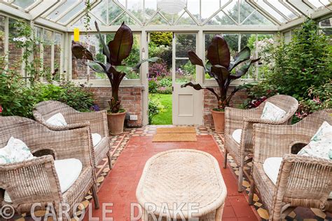 CAROLE DRAKE | Victorian conservatory with wicker furniture surrounded ...