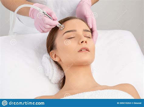 The Cosmetologist Makes The Procedure Microdermabrasion Of The Face