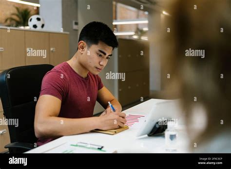 Businessman Working At Hot Desk In Coworking Office Stock Photo Alamy