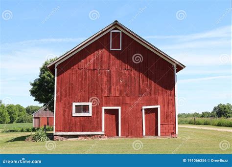 A Front Facing View Of A Wonderful Old Red Barn With White Trim And