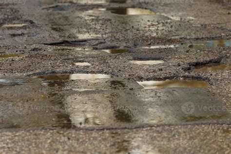 Potholes And Puddles On Bad Broken Wet Asphalt Road After Rain 12627333