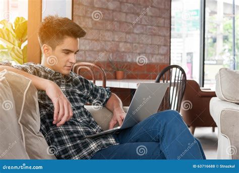 Businessman Using Laptop On Sofa In Coffee Shop Stock Photo Image Of