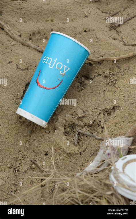 Disposable Blue Single Use Cup Discarded On Beach Object Close Up