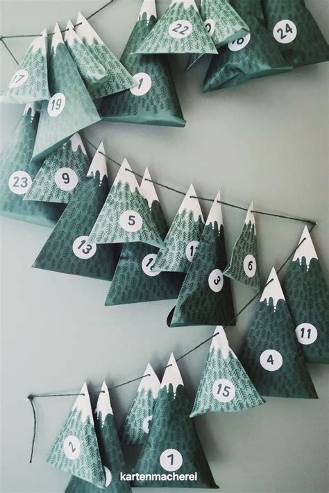 Several Folded Christmas Trees With Numbered Numbers Hanging From The