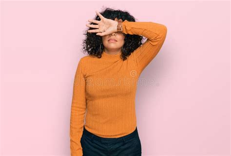 Young Hispanic Woman Wearing Casual Clothes Covering Eyes With Arm