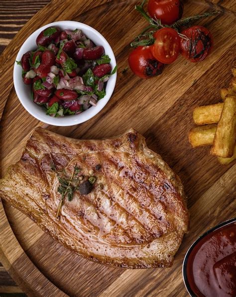 Premium Photo Roasted Pork Steak On Ribs On A Wooden Stand Cherry