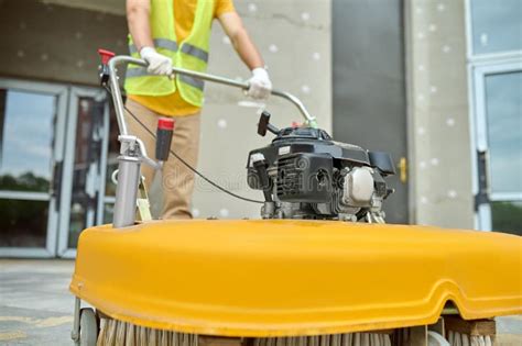 Workman Applying A Road Sweeper On The Construction Site Stock Photo