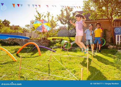 Race With Obstacles Many Kids Jump Over Barrier Stock Image Image Of