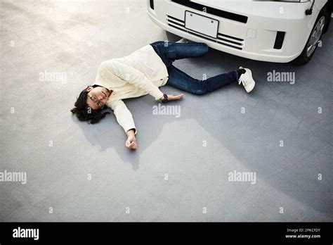 Man Lying In Front Of A Car Stock Photo Alamy