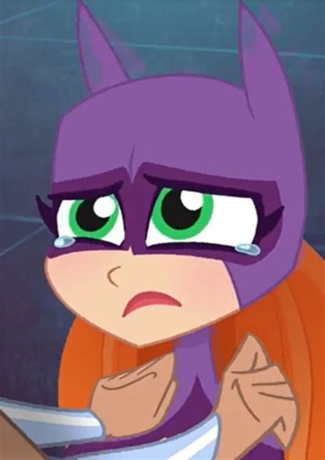 The Animated Batgirl Has Green Eyes And Is Holding A Knife In Her Hand