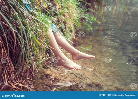 Bare Feet Of The River A Child Enjoying The Outdoors Stock Photo