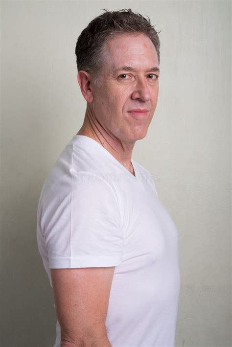 Portrait Of Mature Man With Gray Hair Against White Background Stock