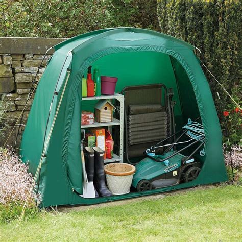 a green tent with gardening equipment in it