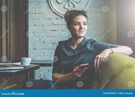 Young Business Woman Sitting In Cafe At Table Leaning His Hand Back In