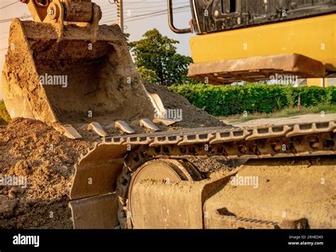 Backhoe Parked At Construction Site After Digging Soil Closeup Bucket