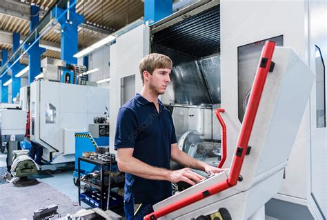 Factory Worker Operating Machinery In Factory Stock Image F0211082