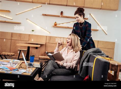 Female Boss Laughing While Having Massage By Assistant Stock Photo Alamy