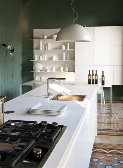 A Kitchen With Green Walls And White Countertops Is Pictured In This