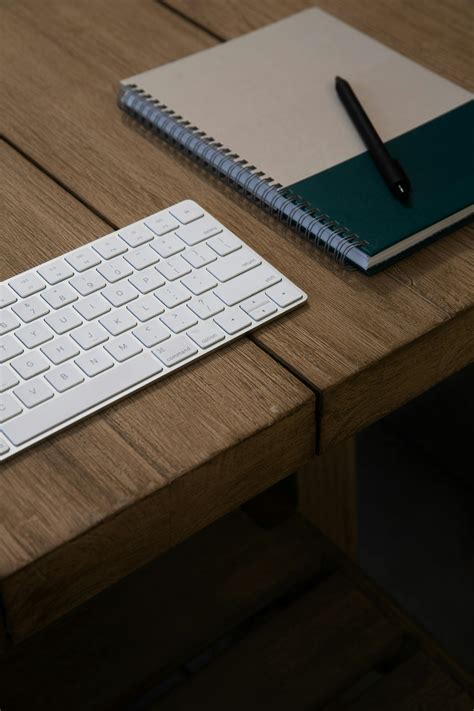 Close-Up Photography of Notebook Near Pens · Free Stock Photo