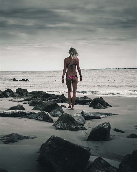 Grey Woman In Pink Bikini Standing In Rocky Beach Ocean Image Free Photo