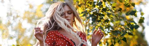Beautiful Blonde Woman In Red Dress Posing Near Trees In Open Field K