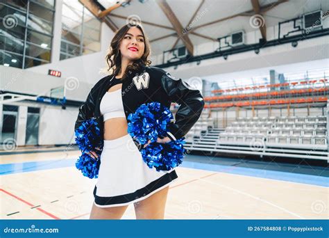 Medium Shot Of Brunette Short Haired Cheerleader In A Jacket Posing