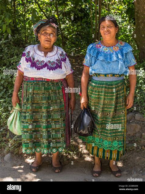 Two Older Tzutujil Mayan Woman In Traditional Dress Pose For A Picture