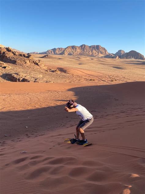 Sandboarding In The Desert Of Wadi Rum ViaVii