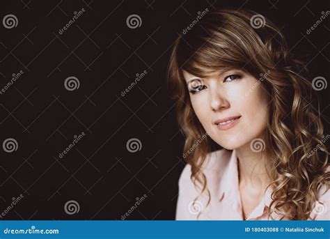 Portrait Of A 36 Year Old Woman With Curly Hair And Brown Slanting Eyes