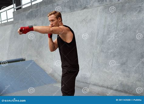 Young Man Stands in Boxing Pose and Doing Punching Workout. Handsome Caucasian Sportsman. Stock ...