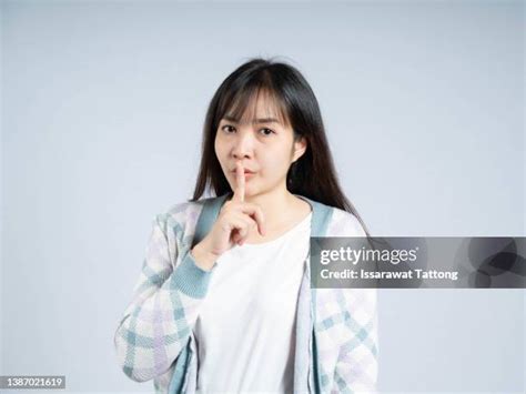 shhh finger stock  high res pictures  images getty images