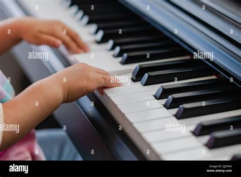 Close Up Of Hands Of Little Girl Playing Piano Selective Focus Stock