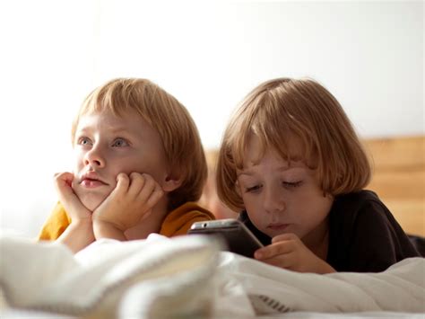 Premium Photo Cute Sibling Relaxing On Bed At Home