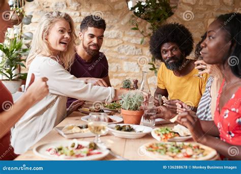 Adult Friends Eating Lunch At A Table In A Restaurant Stock Photo