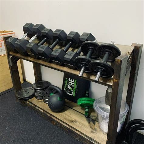 There Are Many Dumbs And Exercise Equipment On This Shelf