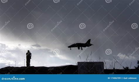 Silhouette Of Spotter Photographer Capturing Photos Of Landing Airliner