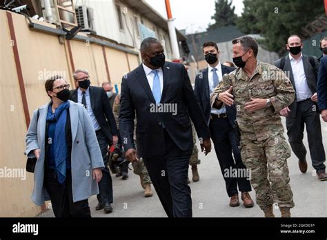 Secretary of Defense Lloyd J. Austin III walks with the commander of ...