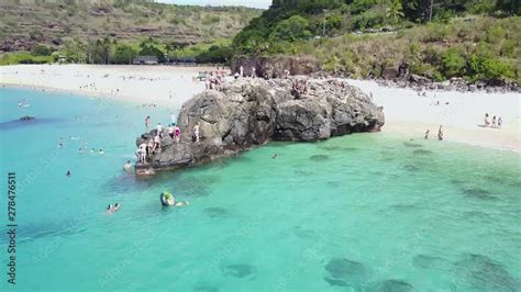 Drone Shot Rotating Around The Rock At Waimea Bay A Large Group Of